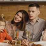 A joyful family gathers for a festive dinner, exchanging warmth and togetherness.